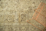 Faded intricate floral vinery and decorative border of a distressed vintage Meshed rug.