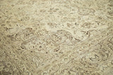 Angled section of distressed Meshed carpet with antique ivory and brown floral patterns.