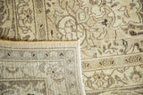 Vintage distressed Meshed rug corner, showing hand-knotted foundation and soft ivory floral pile.