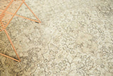 Distressed vintage Oushak carpet with ivory, platinum, and charcoal floral vinery.
