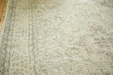Distressed texture of ivory and charcoal floral arabesques on a vintage Oushak carpet.