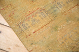 Distressed gold Pak Bokhara rug texture highlighting abrash and faded gul motifs.