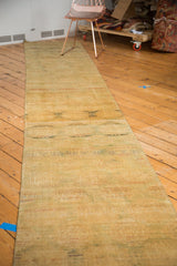 Distressed vintage Pak Bokhara runner with abrash-softened gold, green, and red hues.