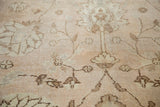 Distressed Oushak rug with pale dusty beige lotus and tendril motifs.