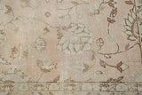 Distressed Oushak rug with pale dusty blush, ivory, and coffee brown lotus flower motifs.