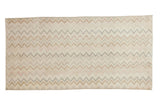 Distressed vintage Oushak rug runner displaying a zig-zag chevron in faded ivory, blush, and bronze.