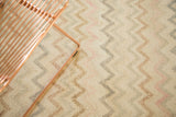 Distressed Oushak rug with faded ivory, blush, and silver zig-zag chevron pattern.