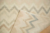 Distressed Oushak rug runner, showing its zig-zag pattern on faded pile and woven foundation.