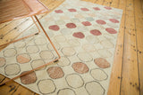 Distressed Oushak rug with playful circles in faded blush, bronze, and ivory.
