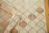 Textured, faded beige and bronze geometric pattern on a vintage distressed Oushak rug.