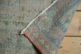Distressed vintage Oushak pile with colorful hand knotted foundation in blue and blush.