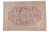 Distressed vintage Oushak carpet with a roundel medallion in faded red, ivory, and silver floral vinery.