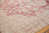 Angled view showing the even wear to the knot heads on a distressed Oushak carpet in faded red and silver.