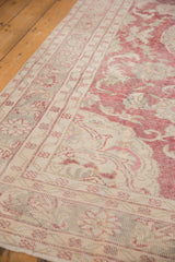 Even wear showing the knot heads and faded red vinery on a vintage Oushak carpet.