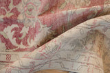 Low pile and hand-knotted texture on the folded corner of a distressed Oushak carpet.