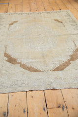 Stepped brown bronze spandrel pattern on a distressed vintage Turkish Oushak rug.