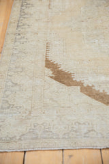 Distressed vintage Turkish Oushak rug showing brown bronze spandrel and faded pattern.