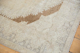 Faded brown spandrel detail on a distressed vintage Oushak rug.