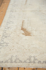Textured pile of a distressed Oushak rug featuring brown bronze and faded silver gray details.