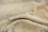 Distressed vintage Oushak rug pile revealing muted beige and subtle bronze tones.