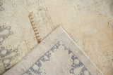 Hand-knotted foundation and distressed soft pile of a light Turkish Oushak rug.