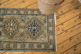 Navy medallion, sea foam green hook and latch vinery, and geometric border of a Vintage Serab runner.