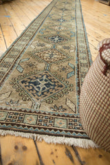 Vintage Serab runner showing navy medallions, seafoam vinery, and starburst leaf motifs.