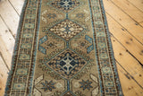 Navy medallion, ivory starburst, sea foam green vinery, serrated leaves on vintage Turkish runner.