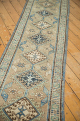 Repeating diamond medallions and geometric sea foam green border on the vintage Serab runner.