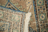 Intricate hand-knotted vintage Serab runner foundation, showing textured fringe and navy blue edge.