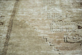 Distressed Oushak carpet texture with pale beige, silver, and charcoal brown abrashes.