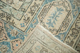 Folded corner of vintage distressed Oushak carpet, showing hand-knotted foundation and secure edge.
