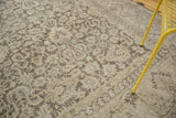 Distressed Sivas carpet detail: allover floral pattern, time-softened tones, visible foundation.