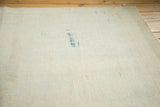 The hand-knotted foundation of the vintage Oushak rug, showing tight weave and blue marks.
