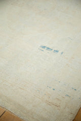 Distressed vintage Oushak rug detail: worn ivory pile with subtle sky aqua blue abrash.