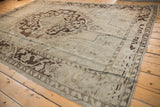 Heavy abrashes across the scalloped medallion of a vintage distressed Oushak carpet.