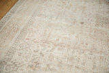 Faded floral and animal motifs with even wear on the vintage Oushak rug pile.