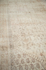 Distressed field and border of a vintage Oushak carpet with antique ivory tones.