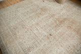 Soft, even wear and muted floral patterns on an ivory and sand distressed vintage Oushak rug.