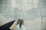 Pale seafoam green vintage Oushak carpet showing quatrefoil floral design and even pile wear.