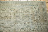 Distressed vintage Kaisary carpet corner, highlighting muted gul motifs, intricate borders, and abrashes.