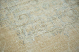 Faded distressed Oushak pile showing wear with ivory, peach, and soft blue tones.