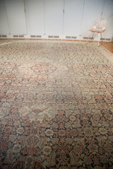 Vintage Sivas carpet's herati motif with even wear, featuring blush, ivory, and oxidized silver tones.