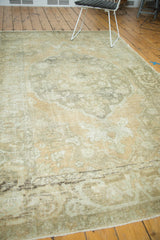 Distressed vintage Oushak rug border, with scrolling design and faded apricot, platinum tones.