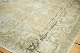 Distressed vintage Oushak carpet corner with time-softened peach, silver, and beige tones.