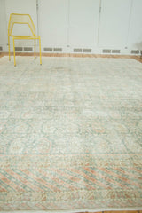 Vintage distressed Oushak with faded Mir Boteh design and barber pole border.