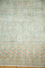 Distressed vintage Oushak carpet, pale terra cotta barber pole border, Paisley motifs.