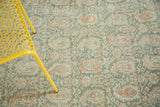 Distressed Oushak rug detail, pale terra cotta Mir Boteh and vinery on sea foam green.