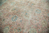 Distressed blush, faded blue, and ivory palmette pattern on vintage Tabriz carpet.