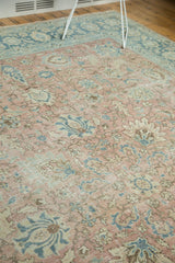 Faded blush and blue palmettes with serrated leaves on a vintage distressed Tabriz rug.